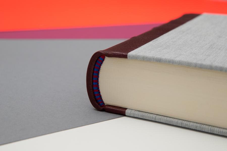 Close-up of the small colored headband at the top of a hardcover book spine