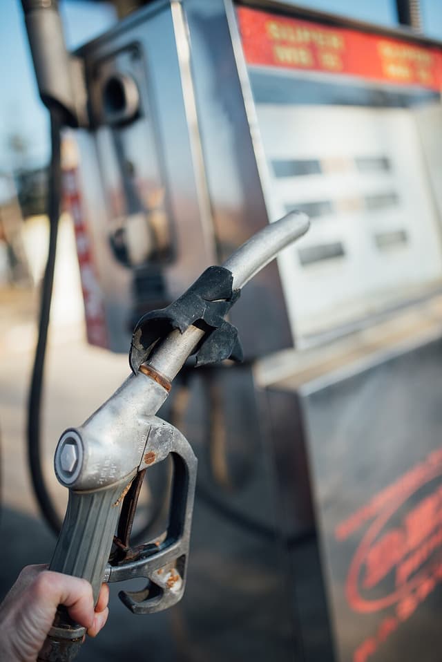 Close-up of a fuel pump nozzle being used at a gas station