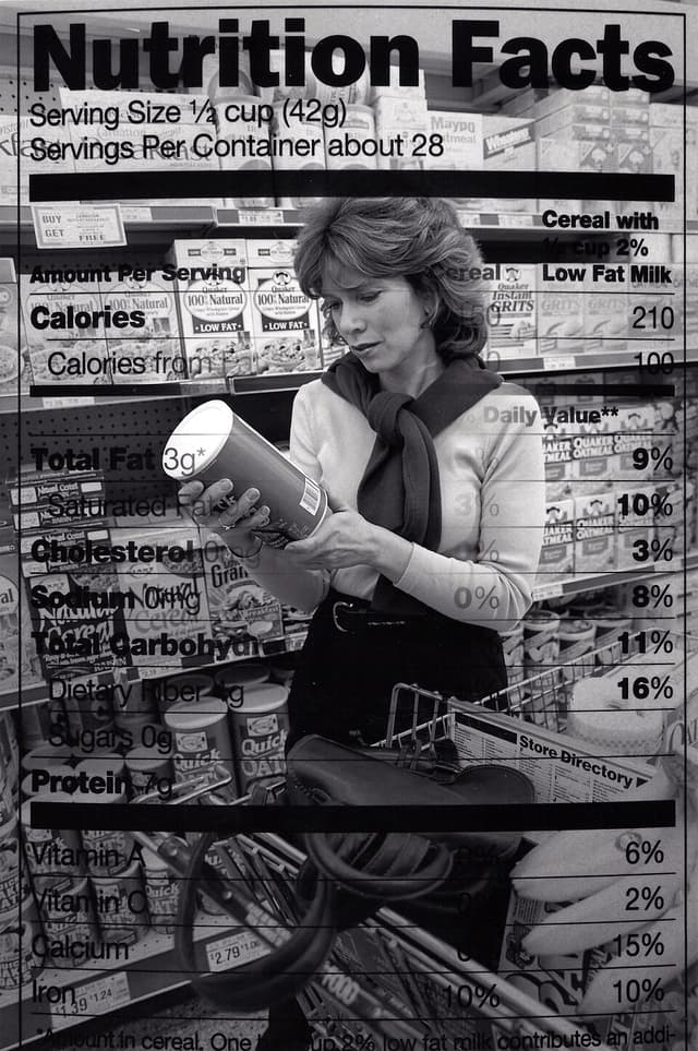 Person examining nutrition information on packaged food