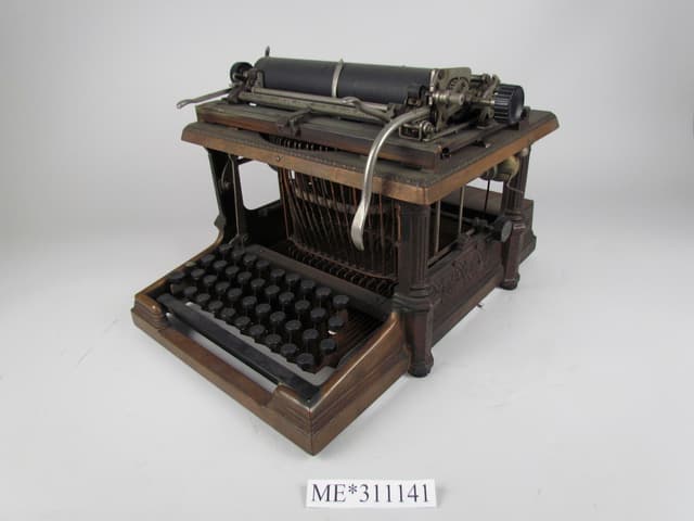 Early Sholes and Glidden typewriter showing the mechanical keyboard that preceded modern QWERTY keyboards