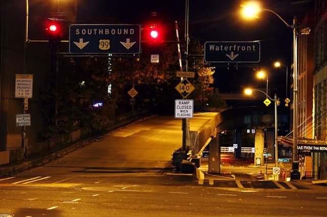 Retroreflective road signs glowing brightly in vehicle headlights at night