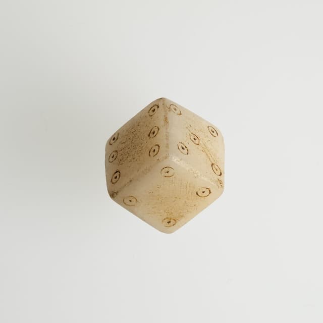 Ancient Roman die with circular pips on several visible faces